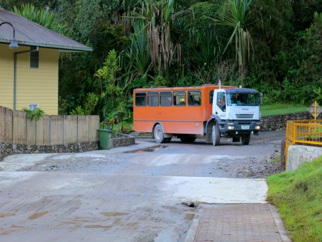 An MZIS school bus coming around the corner to pick-up the students at the bus stop.