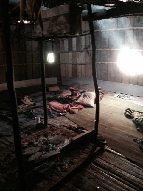 An inside view of the hut.  As expected, it was very primitive and simple-looking.  The only items inside the hut were pillows, blankets, and a pot for cooking/heating water.  The fire pit can be seen in the bottom left corner of the picture.  It is used at night to keep the occupants warm.