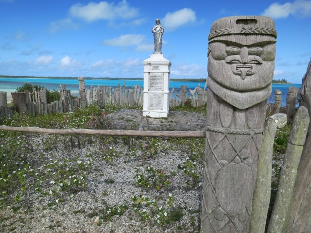 The statue of St Maurice (in the background), commemorates the arrival of the first missionaries on the island. The statue is surrounded by hand carved totems made by the numerous clans of the island.