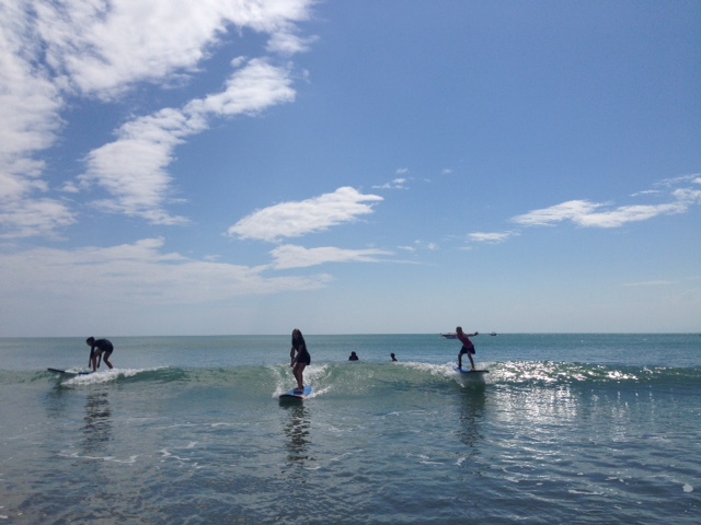 Summer (left), Ally (middle), and Kylee (right) on their surfboards. All three girls caught every single wave they attempted to ride. Best surfing ever!