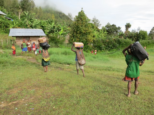 Women and children grabbed our bags and boxes of goods and took them to John's house for us.