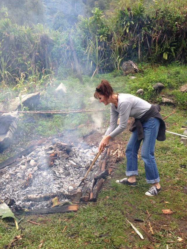 Filling the pit with hot rocks.