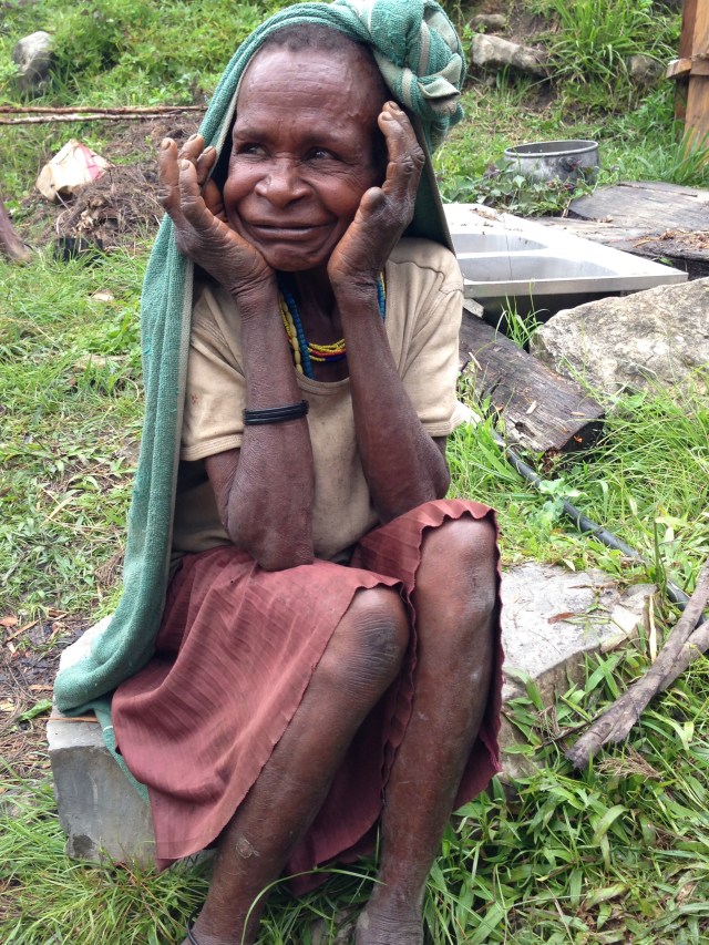 A mini woman with her hands cupping her head. Notice finger