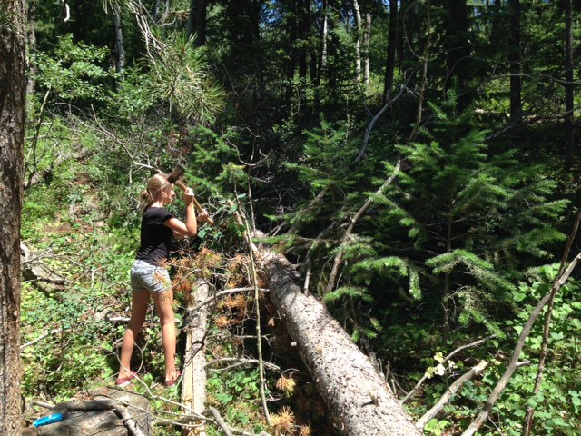 Ally cutting firewood for our campfire.